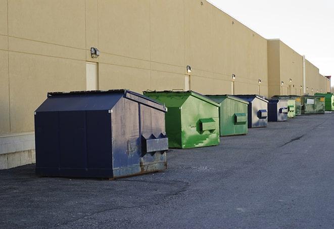 construction dumpsters stacked in a row on a job site in Madison